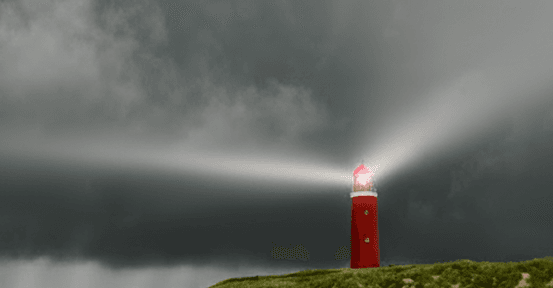 Red lighthouse cutting through fog with a strong beam